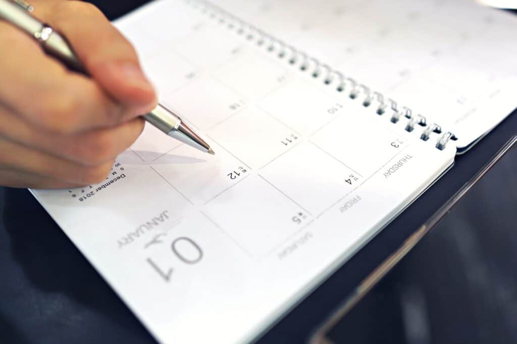 Female planning schedule and appointment on calendar planner