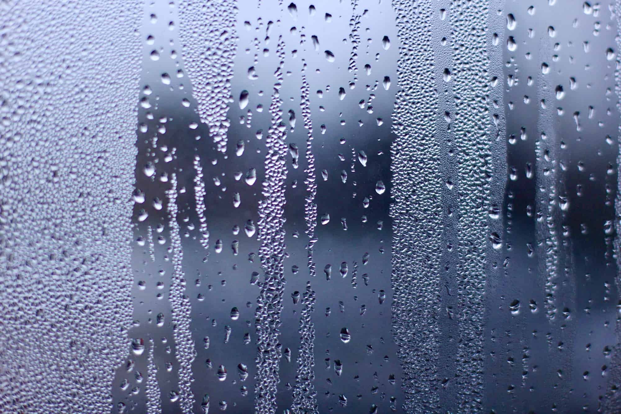 Water drops on the window glass. Condensation. Rain. Abstract background texture.