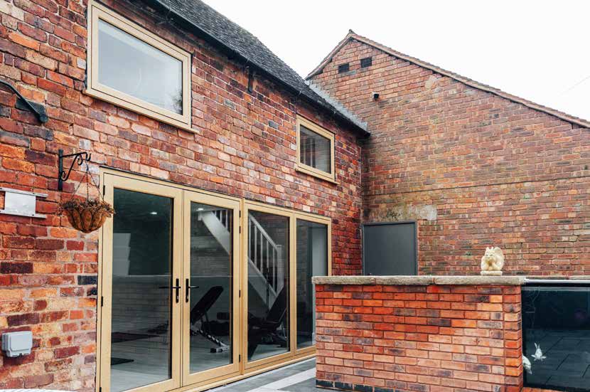 A brick house with a patio and an R2 glass door.